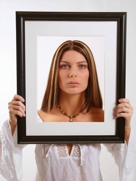 Framed portrait of a woman with caramel and blonde highlights