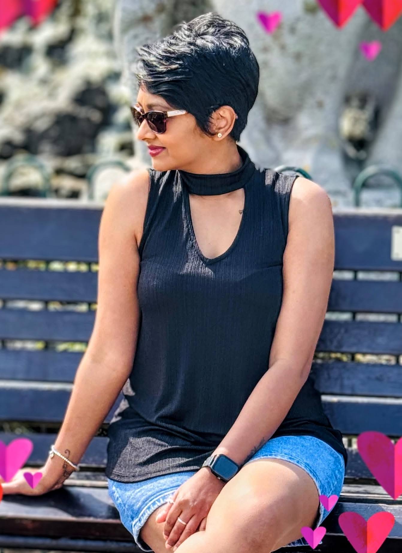 Ladies dark pixie cut swept off the face, worn with sunglasses