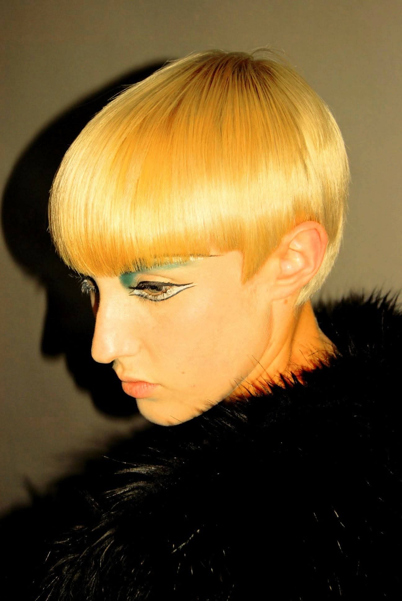 Editorial blonde bowl cut with a strong graphic fringe