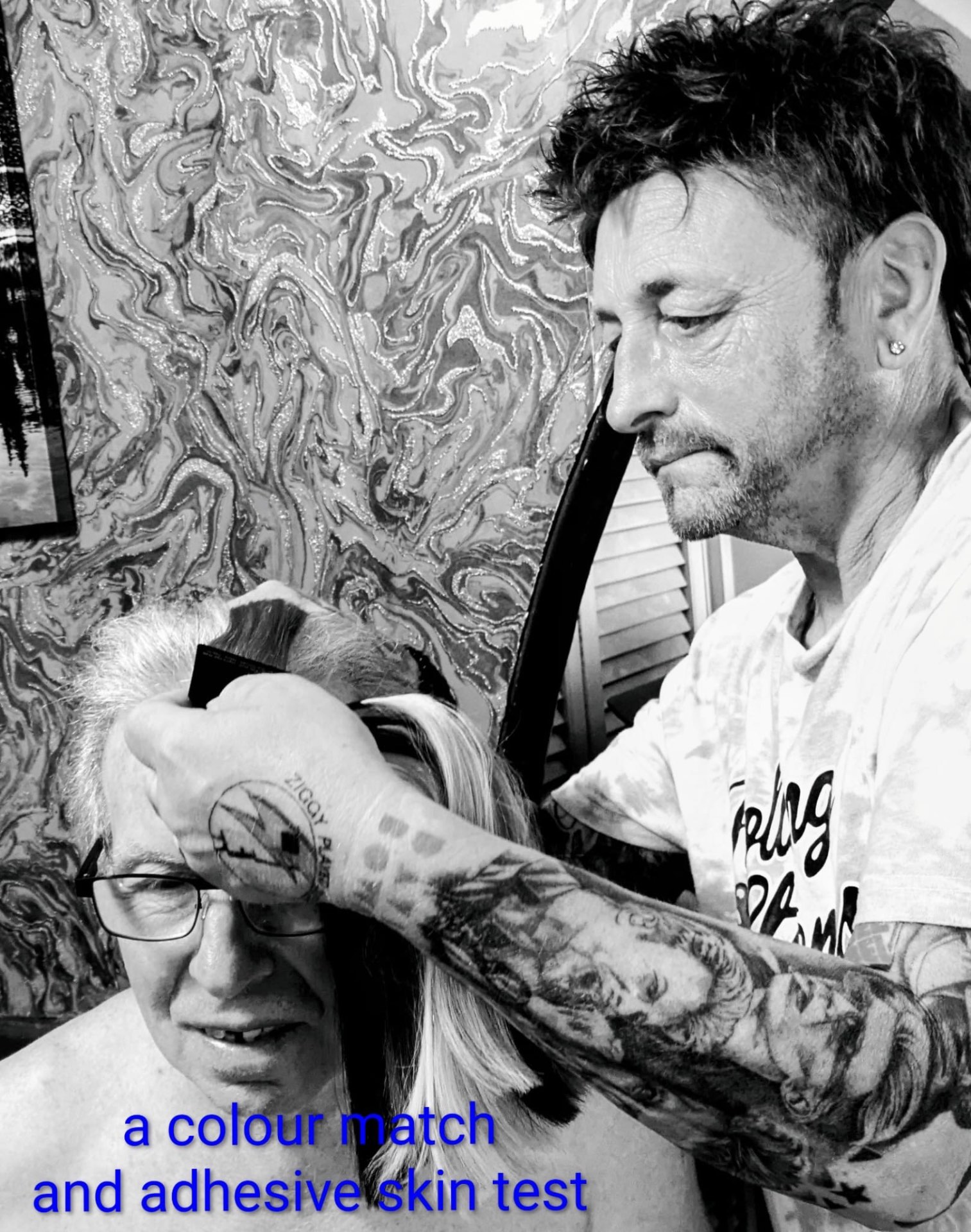 Sean carrying out a colour match and adhesive skin test during a hair system consultation
