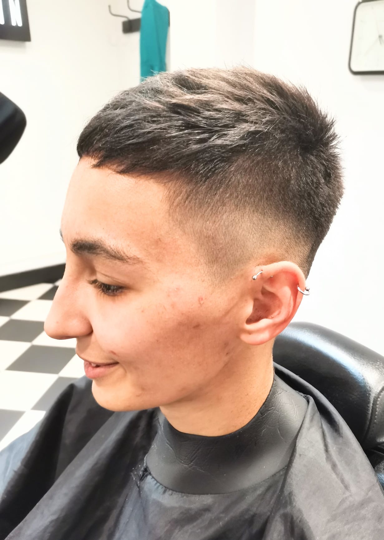 Ladies short fade — side profile showing tapered fade and textured top